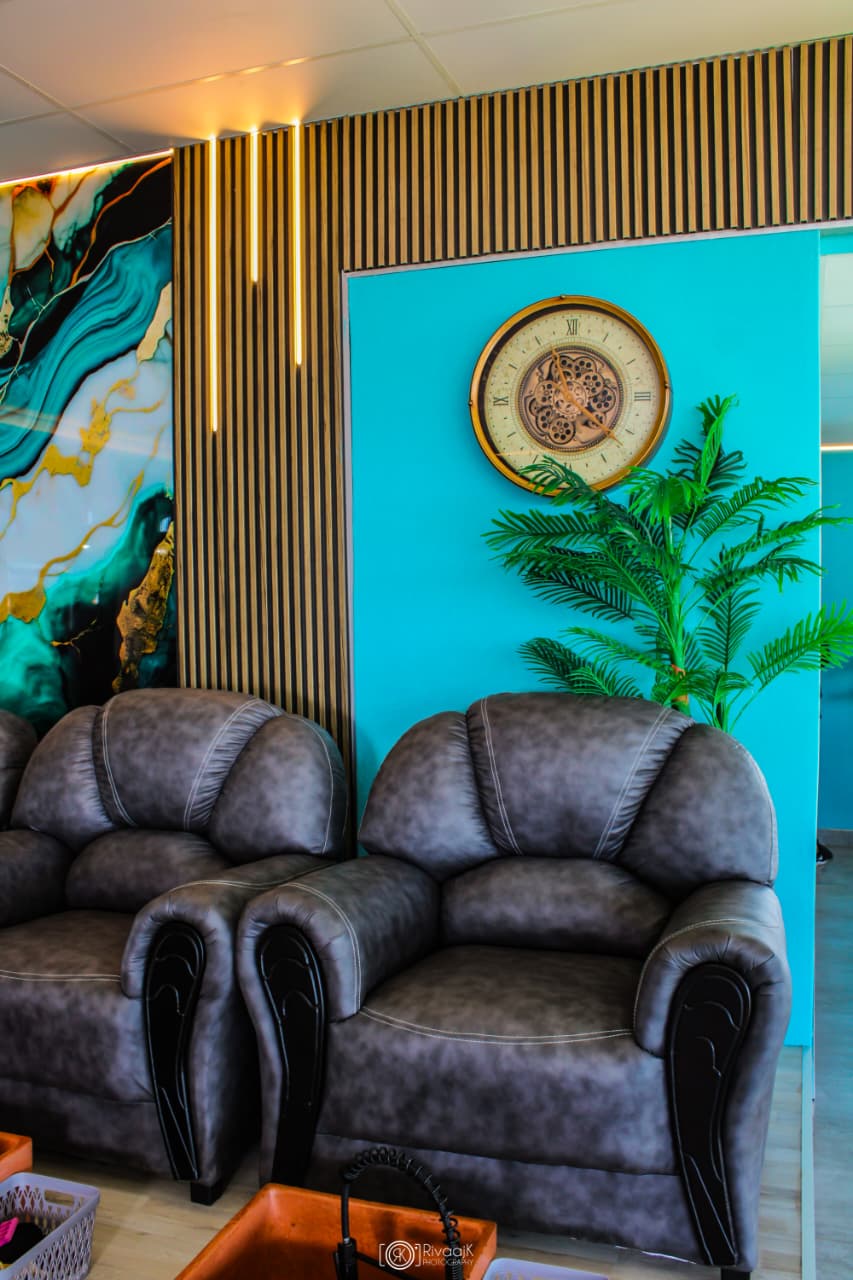 Pedicure lounge seating and turquoise wall